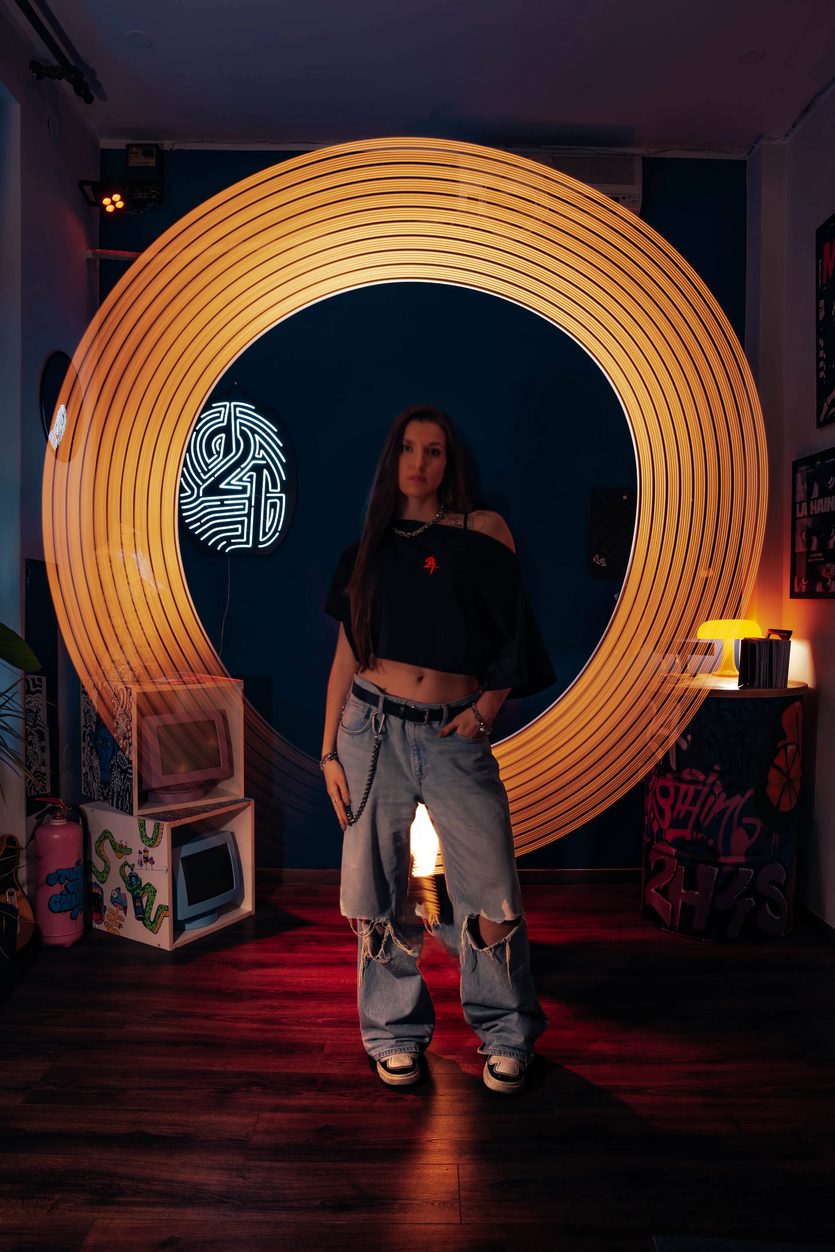 Model centred in a ring of spun light, the 2H4S neon burning behind her