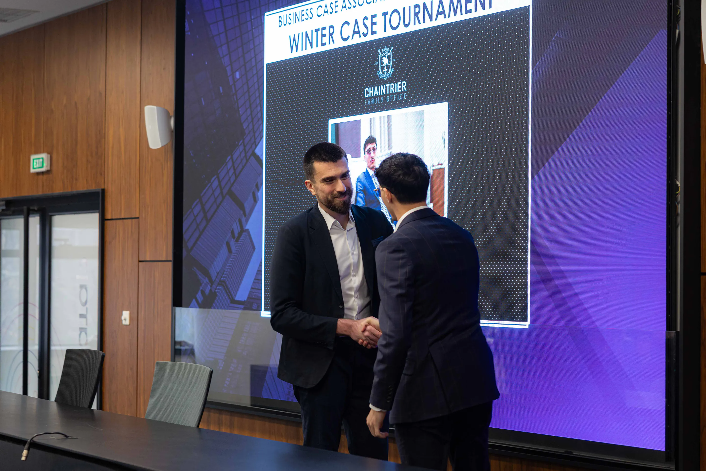 A handshake in front of the tournament screen