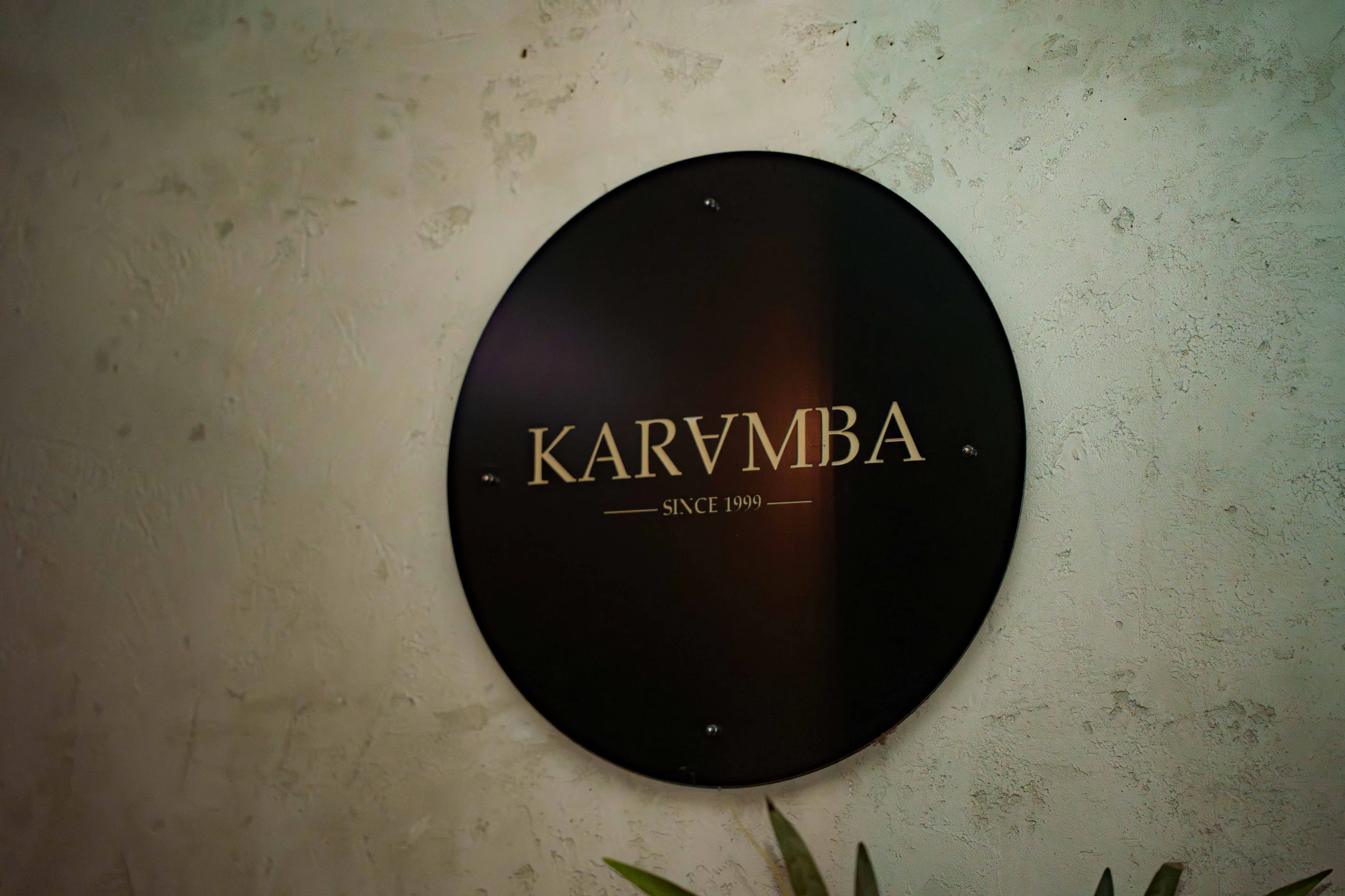The Karamba sign — gold on black, since 1999 — on the stone wall